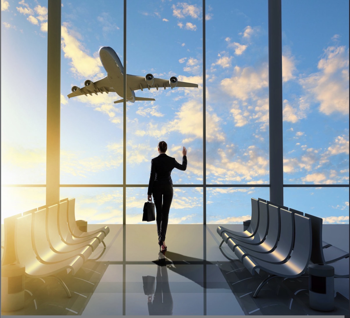 Traveller watching a plane take off from an airport terminal